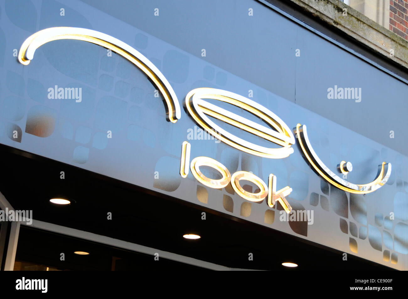 New Look high street retail clothing shop store sign above shop front & entrance in High Street