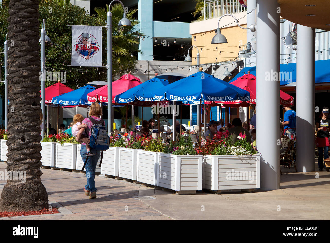 diners eating on the patio outside Bubba Gumps restaurant at The Pike Rainbow Harbor Long Beach California USA Stock Photo