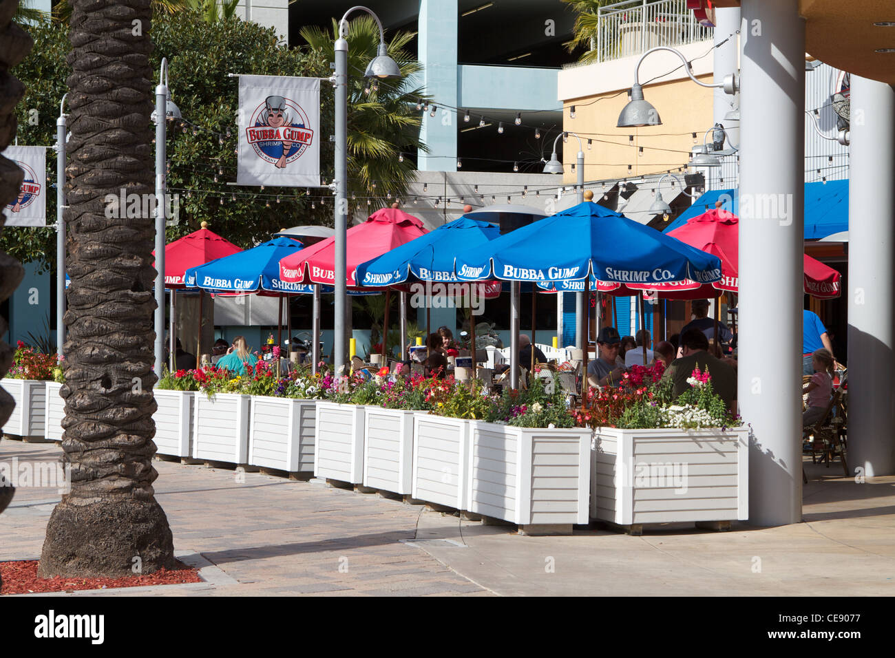 diners eating on the patio outside Bubba Gumps restaurant at The Pike Rainbow Harbor Long Beach California USA Stock Photo