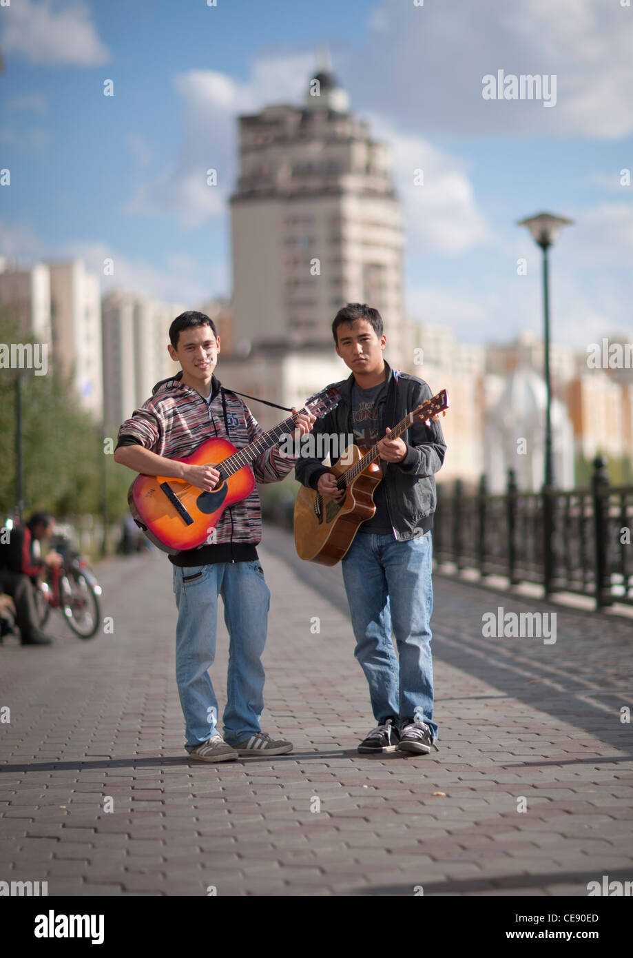 Musicians playing guitar in the street, Astana, Kazakhstan Stock Photo