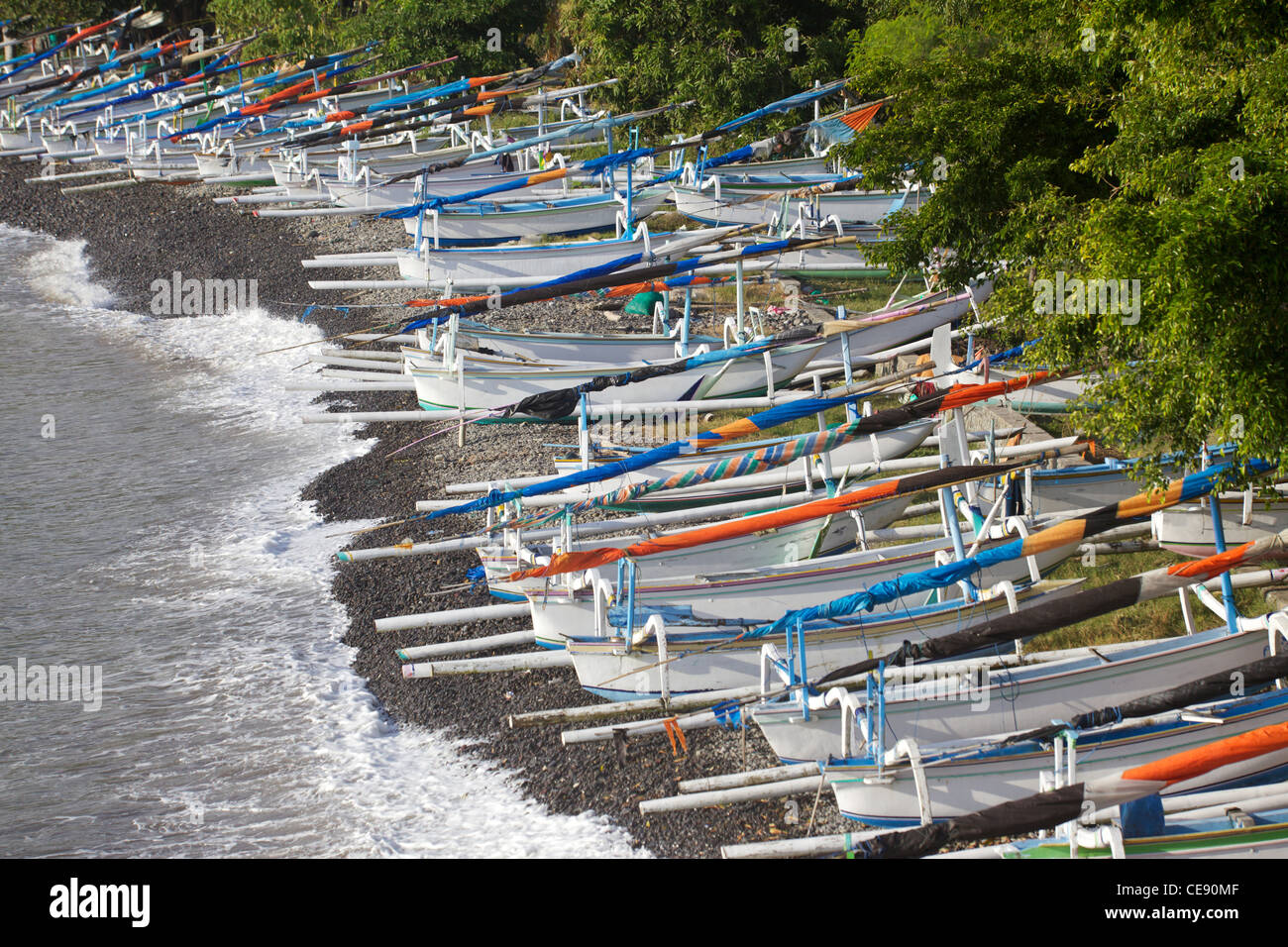 Traditional jukungs (outrigger fishing/sailing canoes) on Amed's 'Japanese Wreck' beach in Eastern Bali. Stock Photo