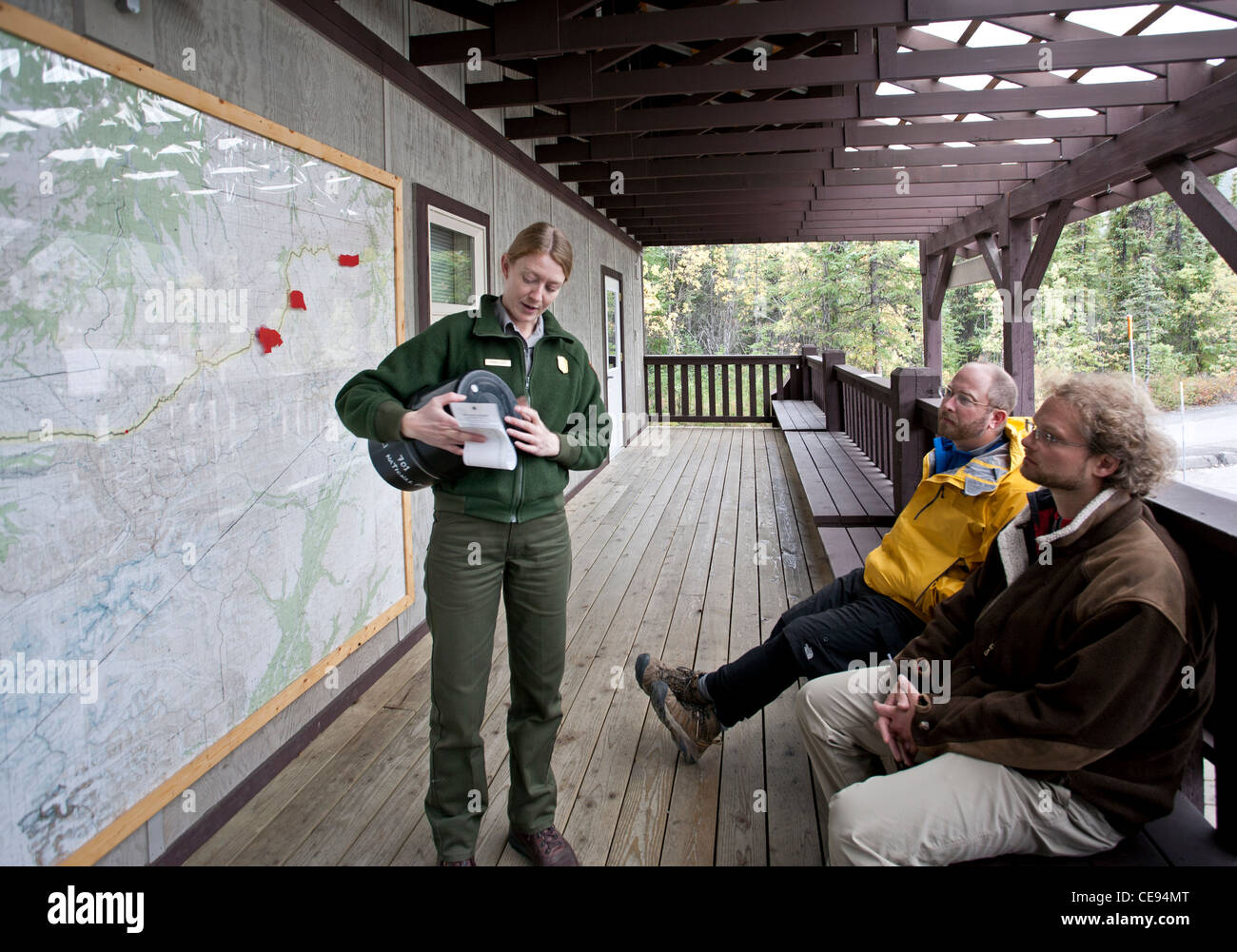 Park ranger explaining how to use a bear resistant food canister. Backcountry Information Center. Denali National Park. Alaska. Stock Photo