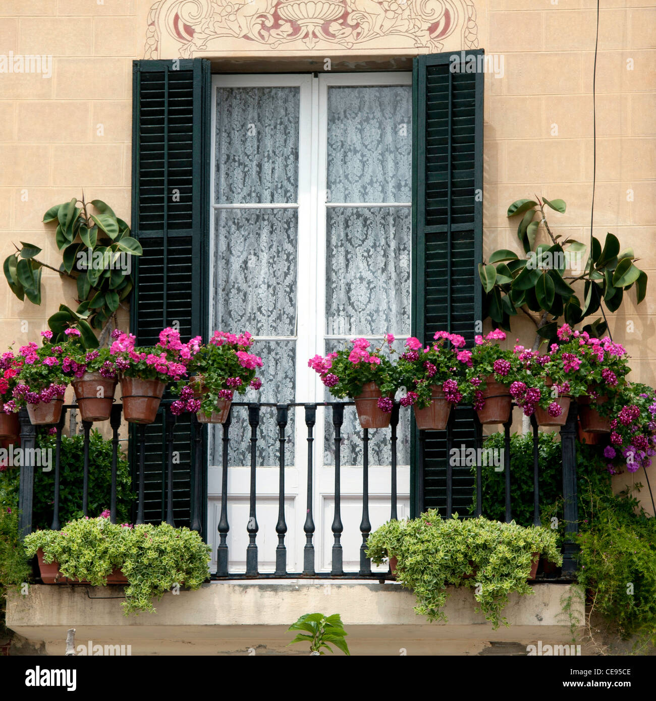 Decorative window with shutters and window boxes in Sitges Spain Stock Photo