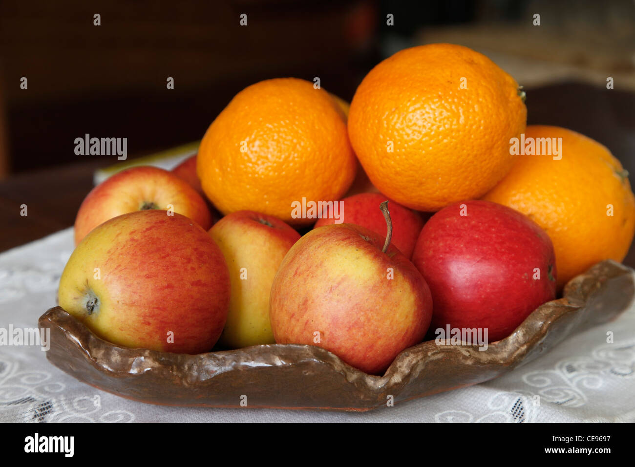 fruit bowl containing oranges and apples Stock Photo