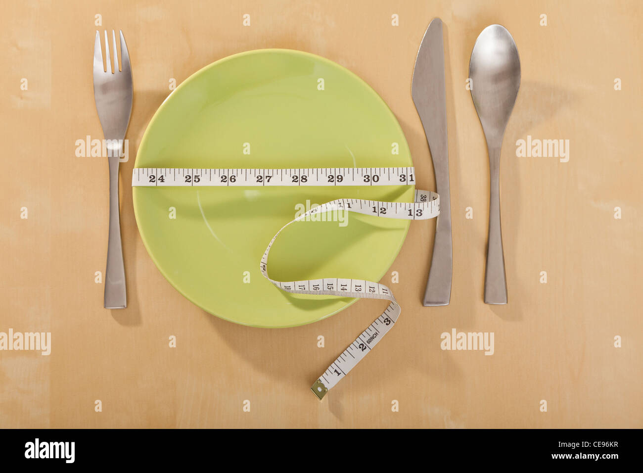 Plate wrapped in tape measure Stock Photo
