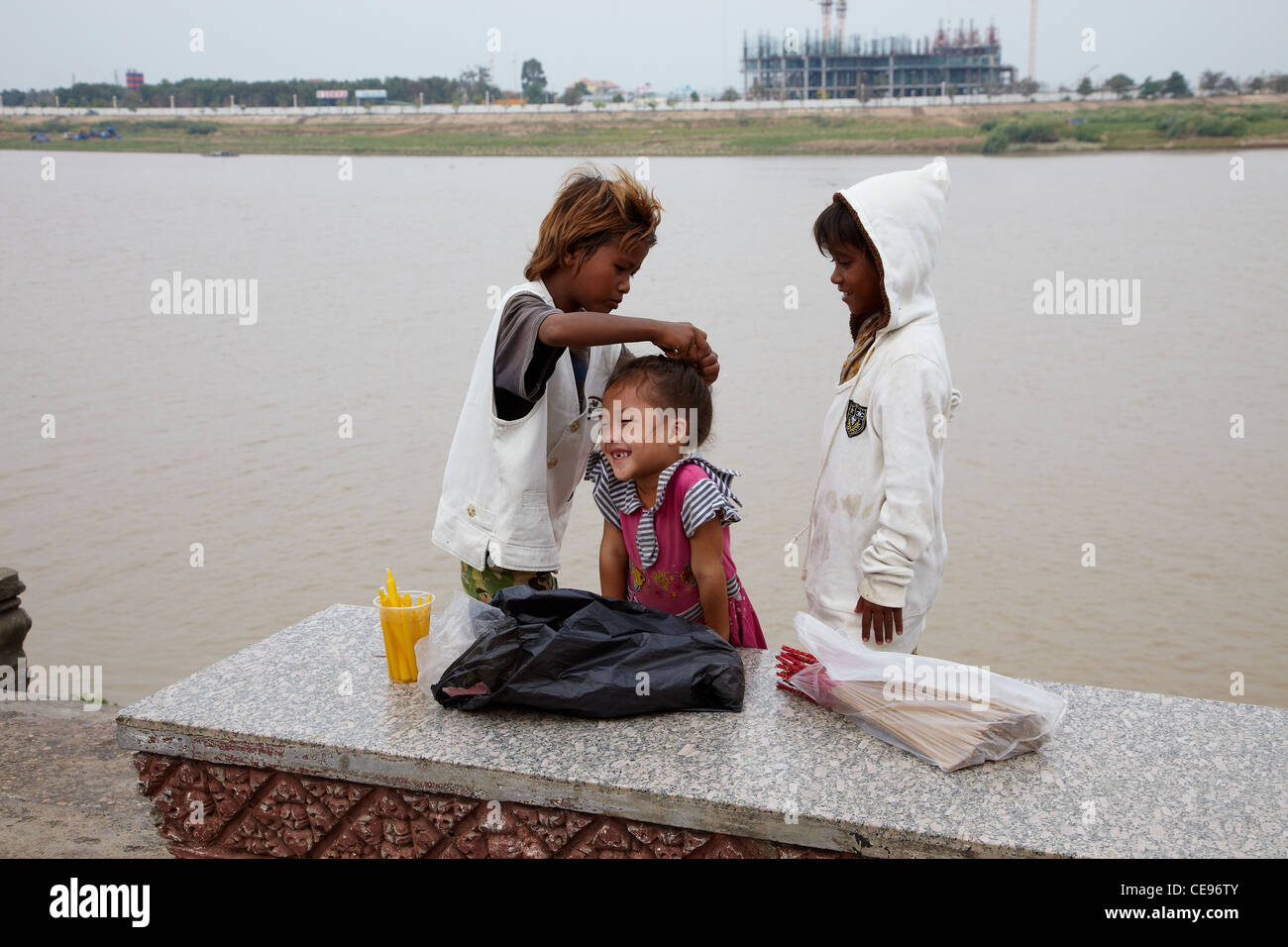 Sri Lankan children looking after each other by the riverside. Stock Photo