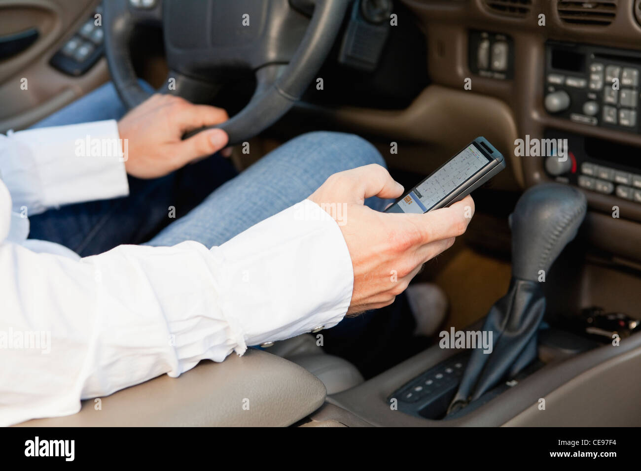 USA, Illinois, Metamora, driver's hands holding cell phone Stock Photo