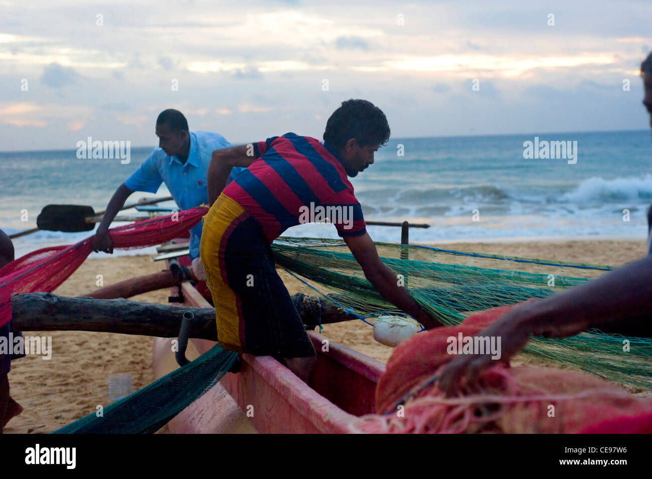 Group of Sri Lankan fishermen packing fishing net. Fishing in Sri Lanka