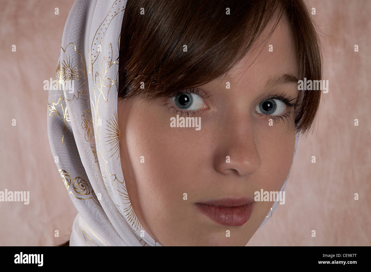 Portrait of the girl in a kerchief in an interior Stock Photo