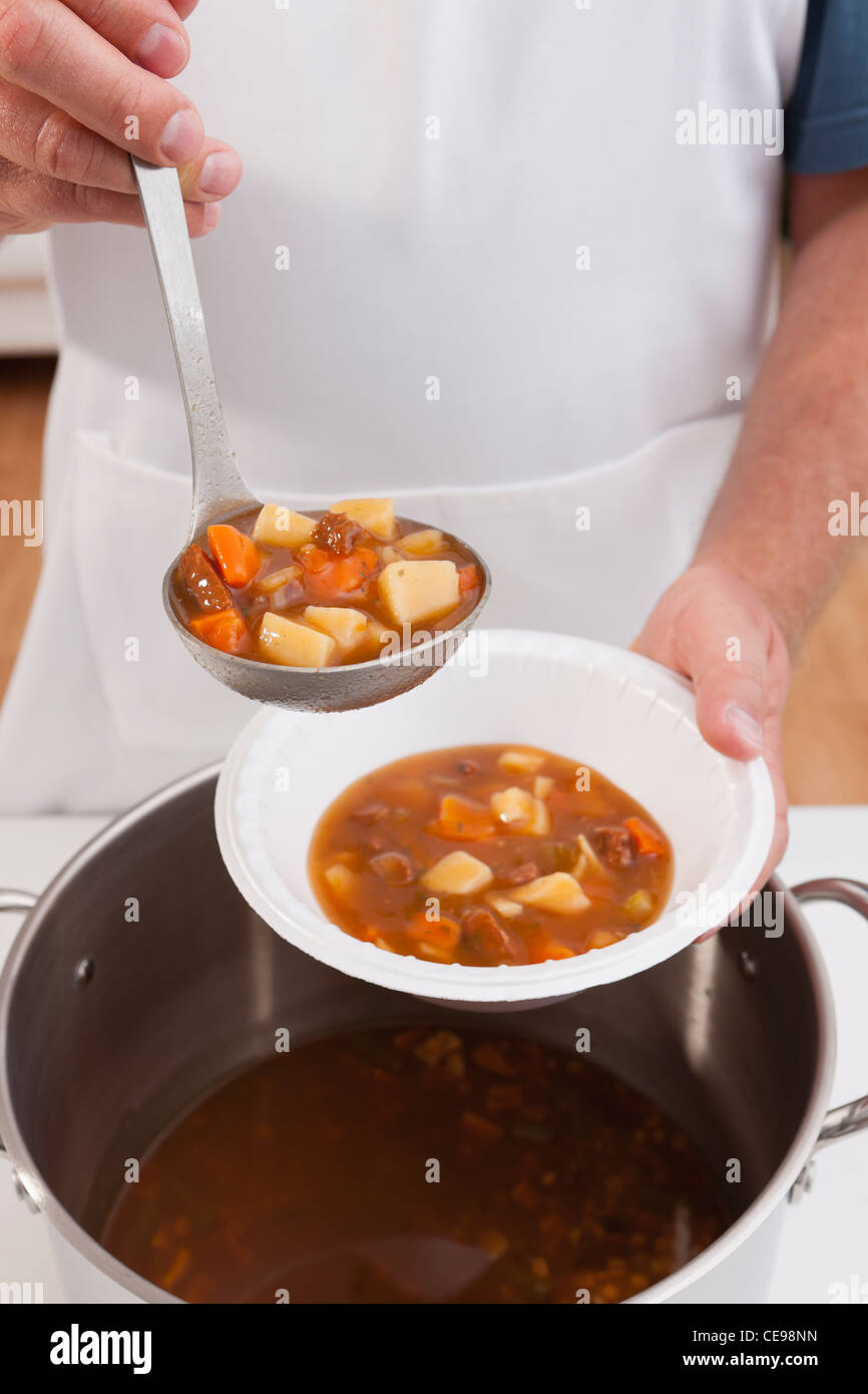 USA, Illinois, Metamora, Volunteer serving soup Stock Photo