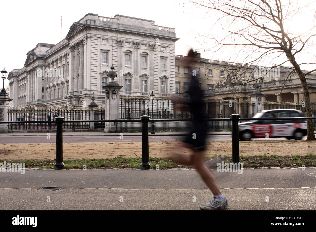 Buckingham Palace with a jogger running in the foreground and a