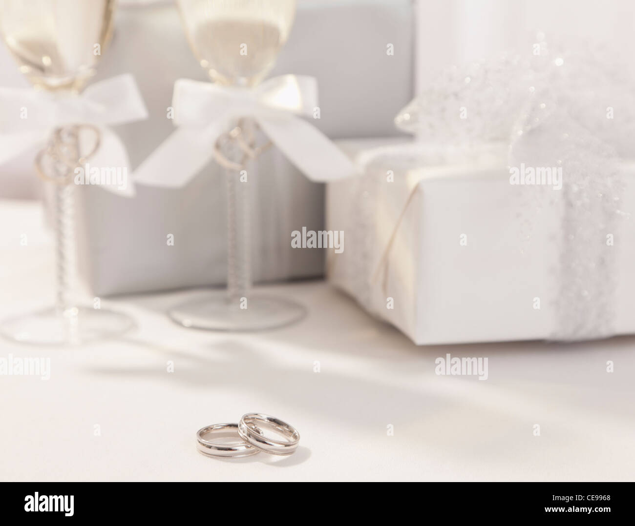 Wedding rings, champagne flutes and wedding presents Stock Photo Alamy