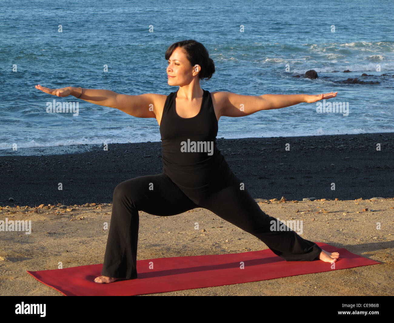 Yoga Warrior Pose, Beautiful Woman at the Ocean, Nature Stock Photo