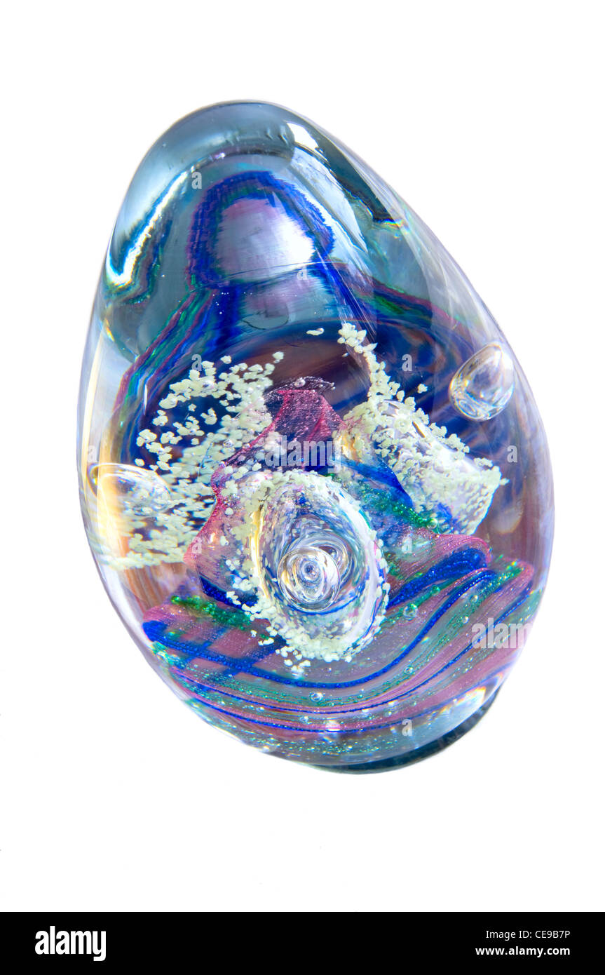 Oblong miniature glass ornament decorated with layers of colored material inside Stock Photo
