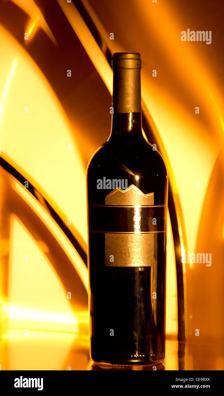 A wine bottle with a dreamy golden background lit by the rising morning sun Stock Photo
