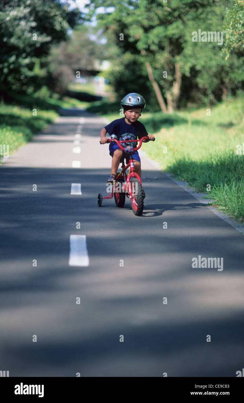 Young boy riding bike with helmet Stock Photo Alamy