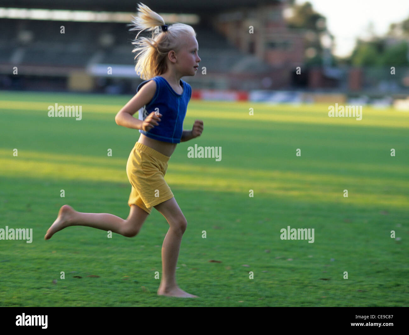 Young girl running age 7 Stock Photo Alamy