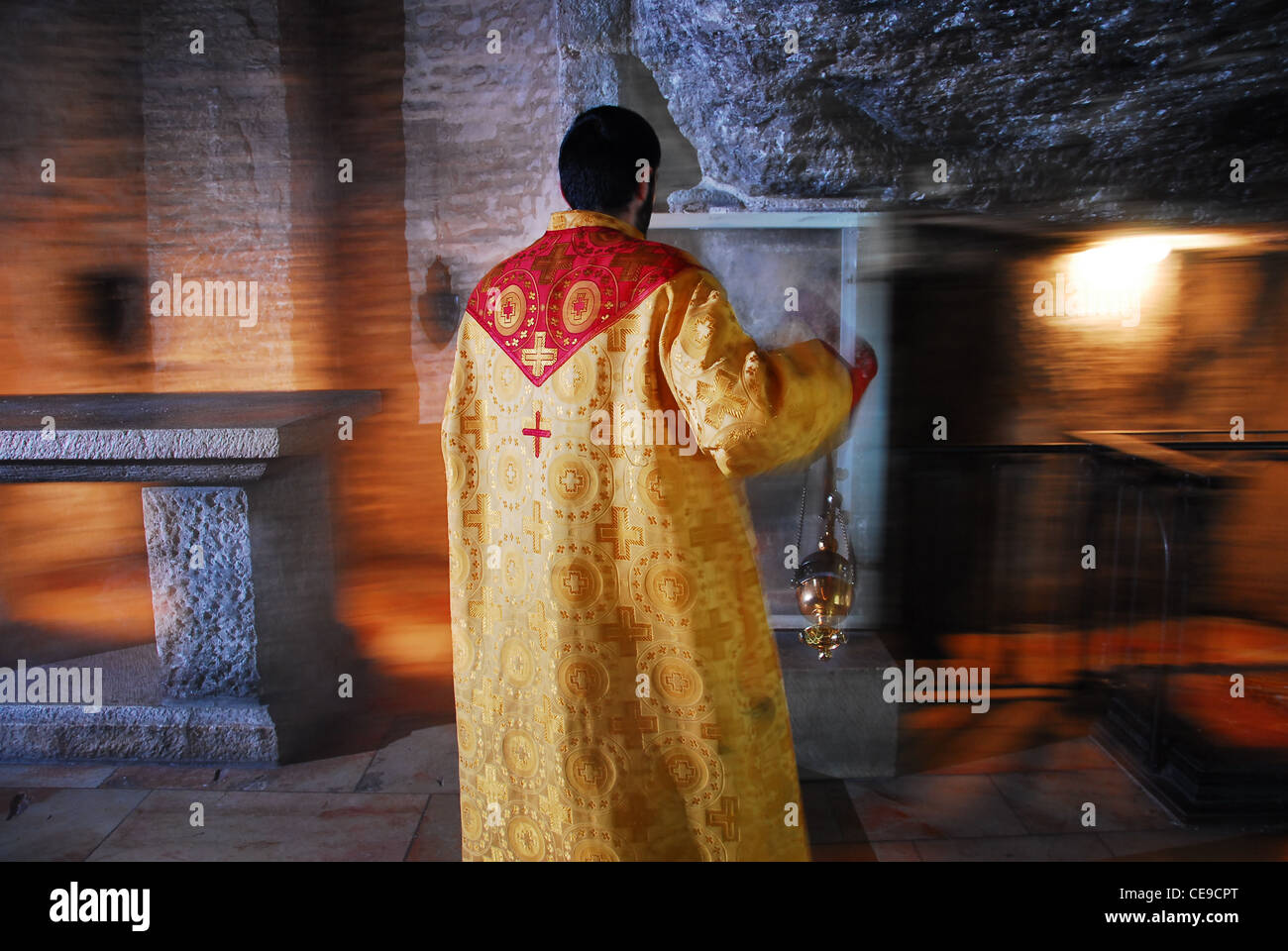 priest in golden robes conducting the ritual consecration of the Stock Photo