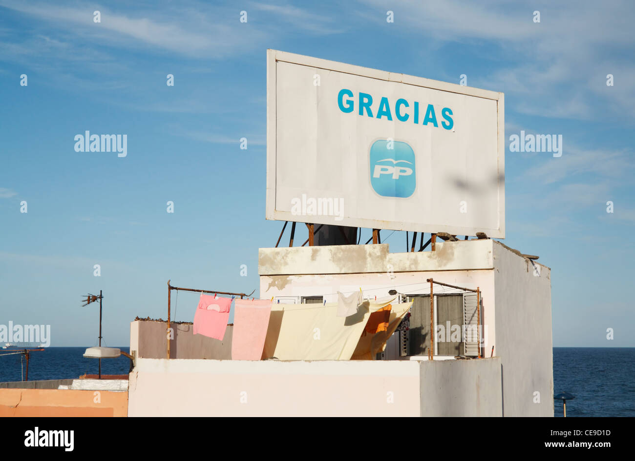 Campaign billboard on house overlooking sea for Partido Popular (PP) who won the general election in November 2011 Stock Photo