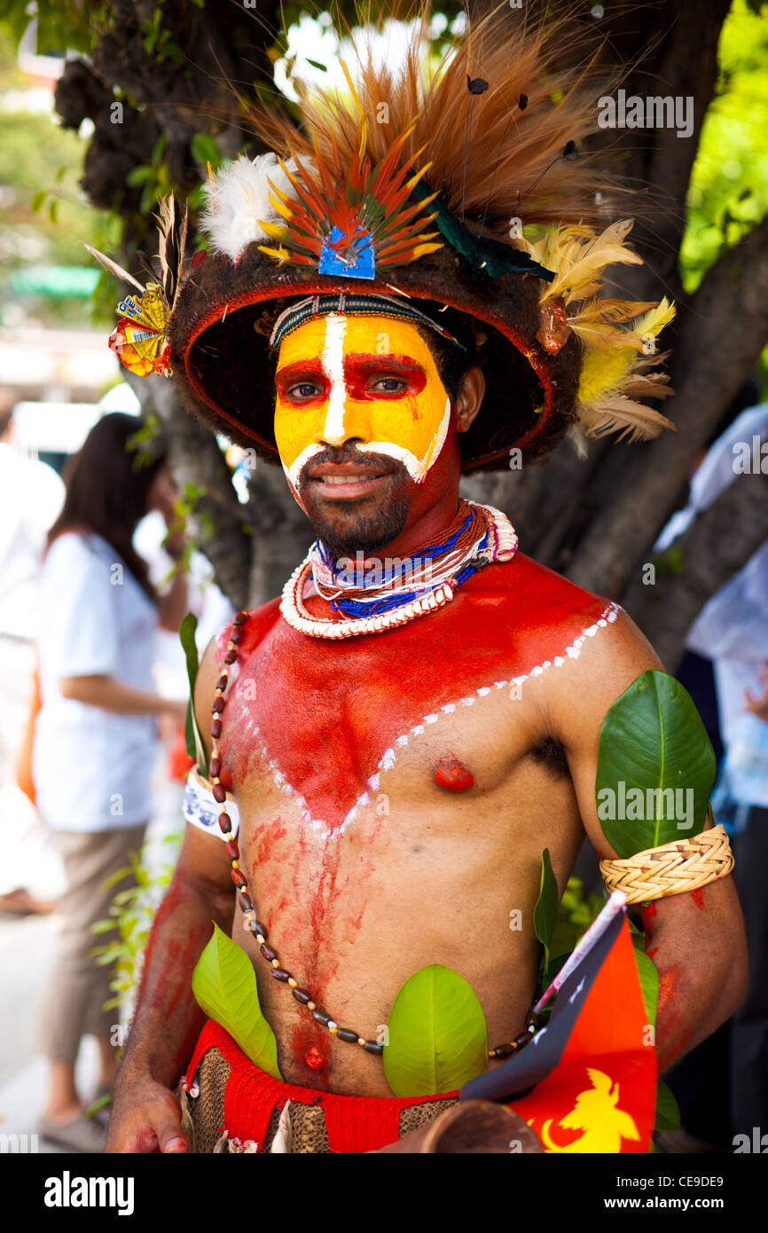 Papua New Guinea tribesman dressed in traditional tribal colors, feathers and decoration for a performance Stock Photo