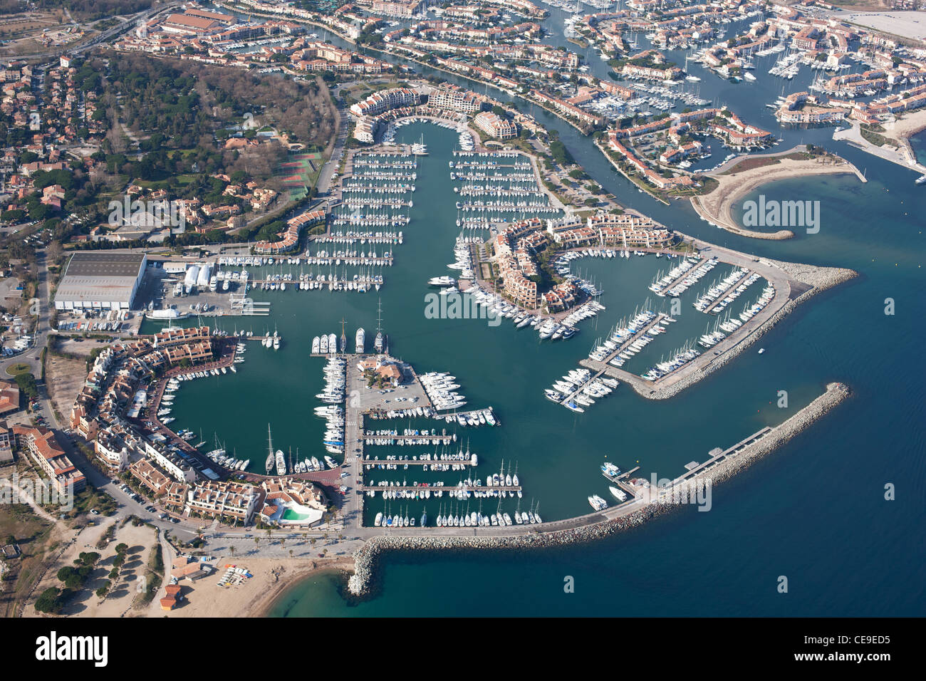 AERIAL VIEW. Les Marines de Cogolin and Port Grimaud in the upper right. Gulf of Saint-Tropez. Var, French Riviera, France. Stock Photo