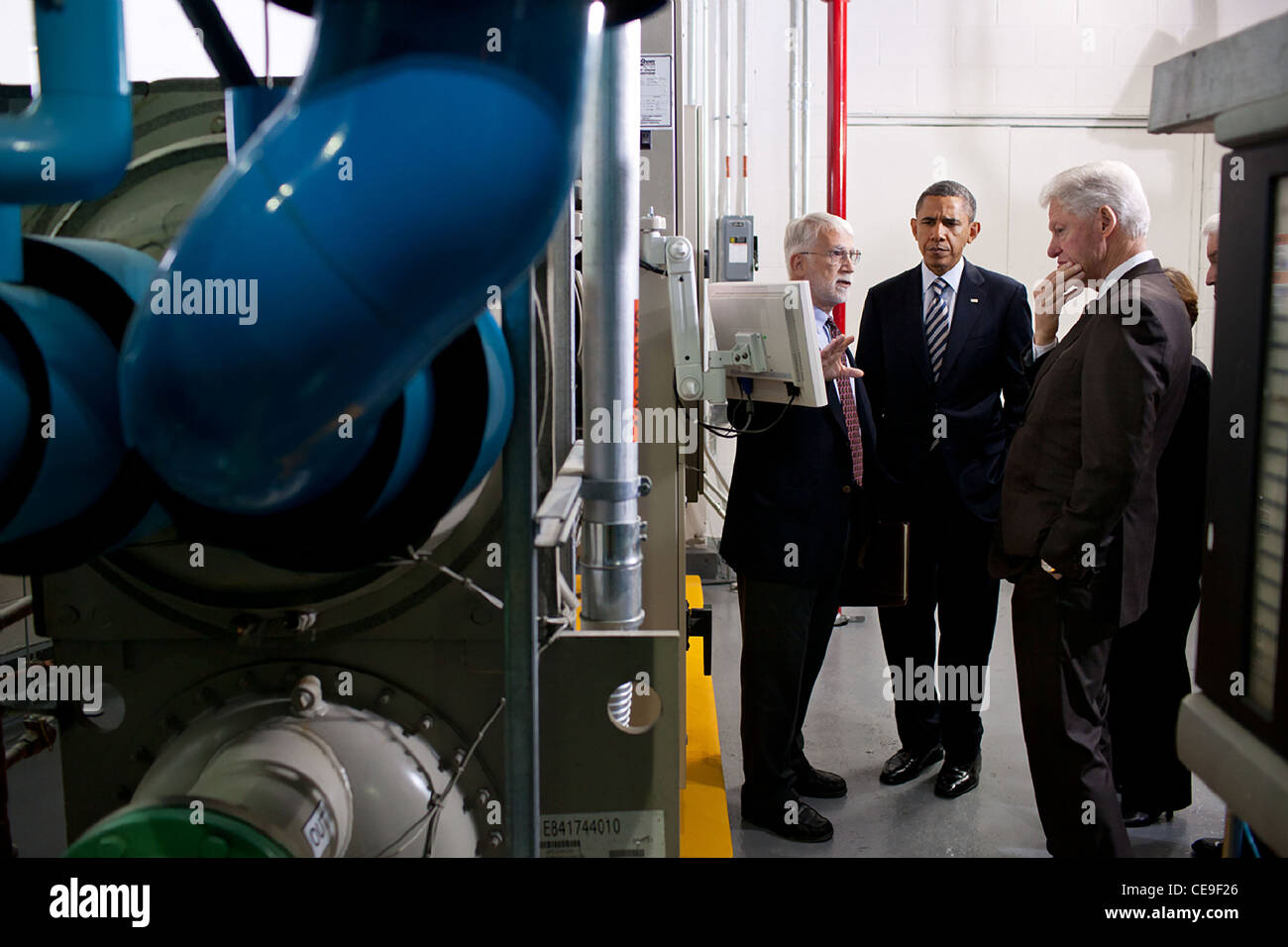President Barack Obama and former President Bill Clinton listen as Gary Le Francois, Senior Vice President and Director of Engineering, leads them on a tour of the Trans-Western Building December 2, 2011 in Washington, DC. Stock Photo