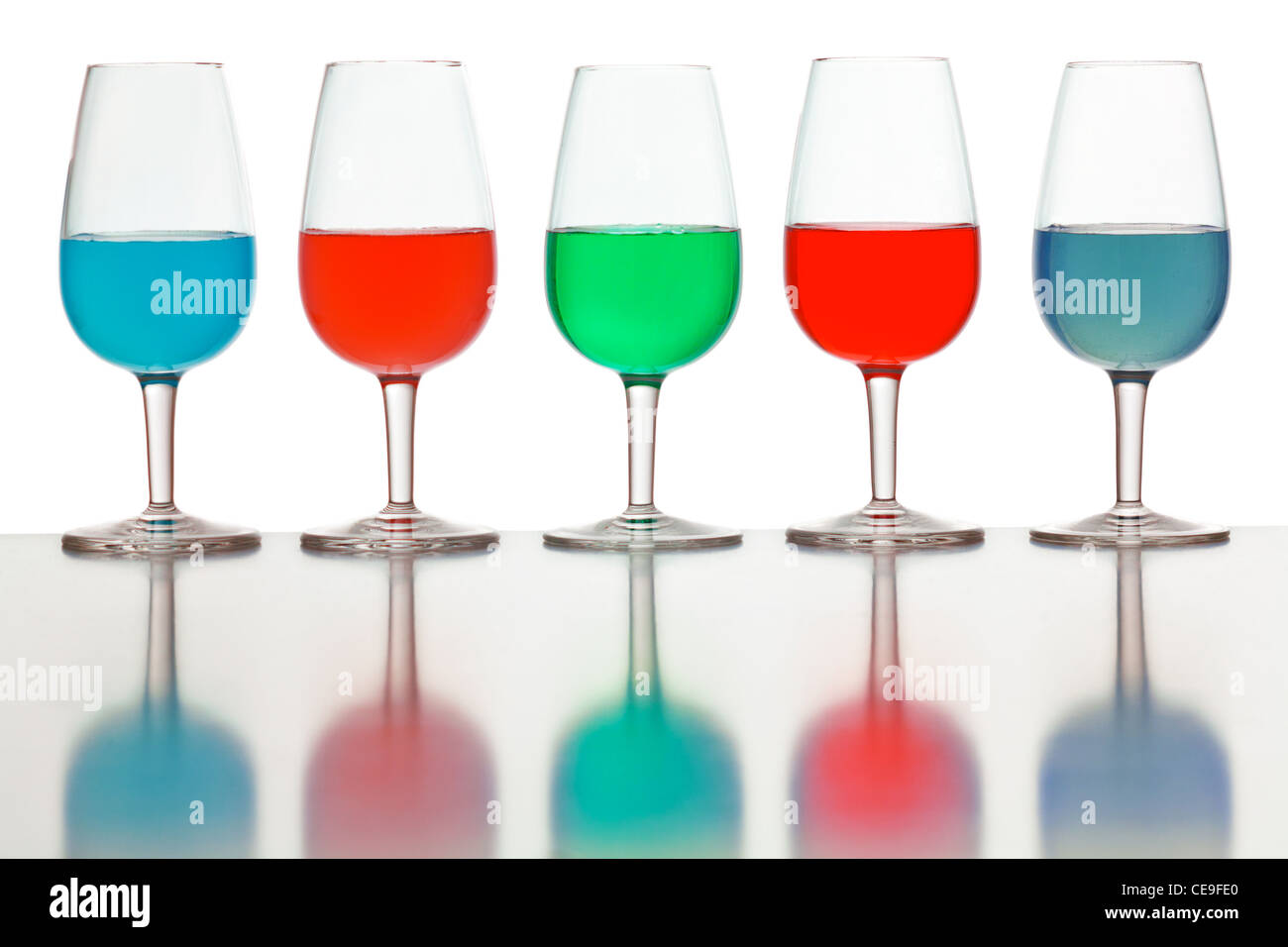 glasses of colored liquid photographed on a white background Stock Photo