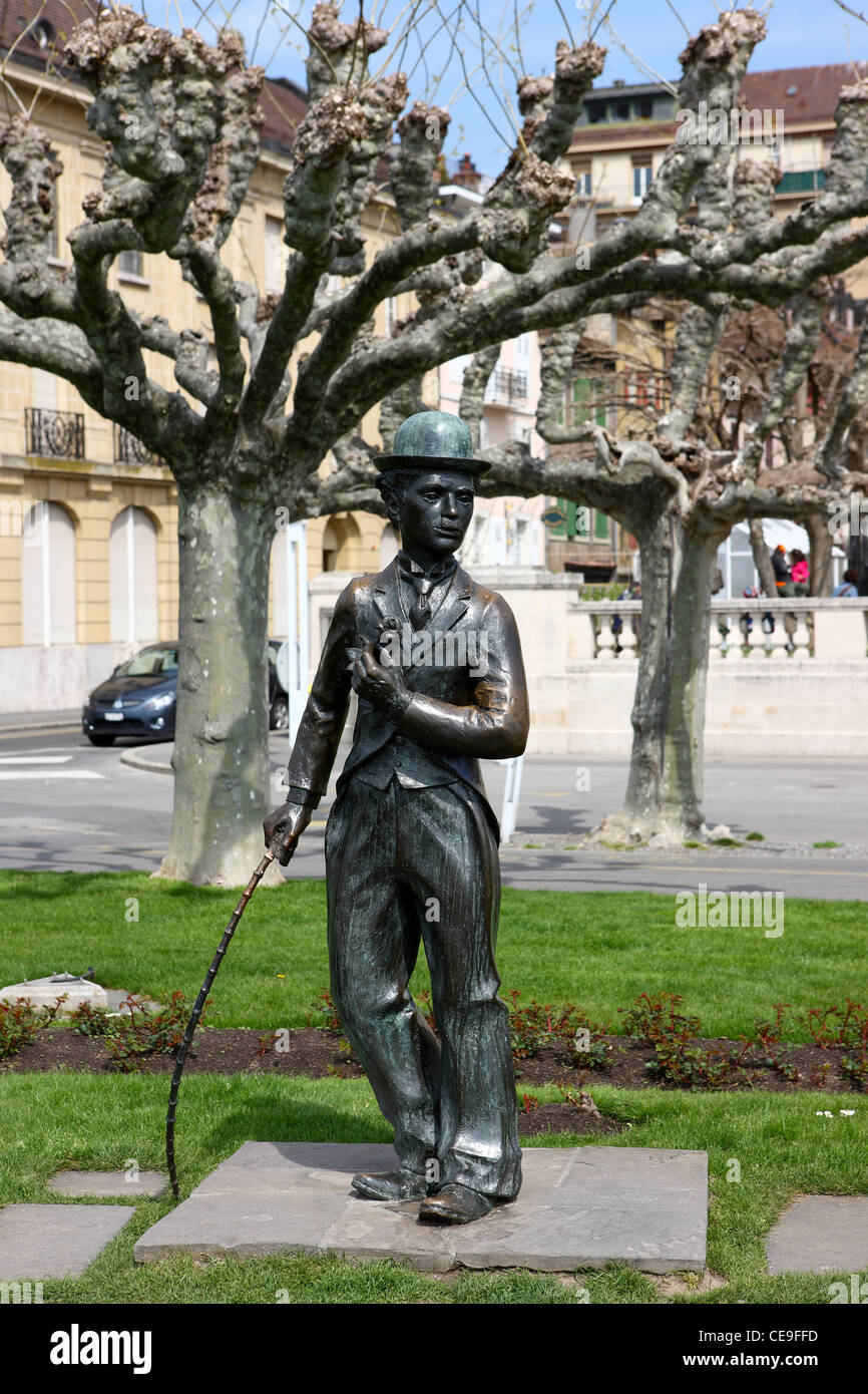 Life-size statue of Charlie Chaplin, in Vevey, Switzerland. In the background are the plane trees. Stock Photo