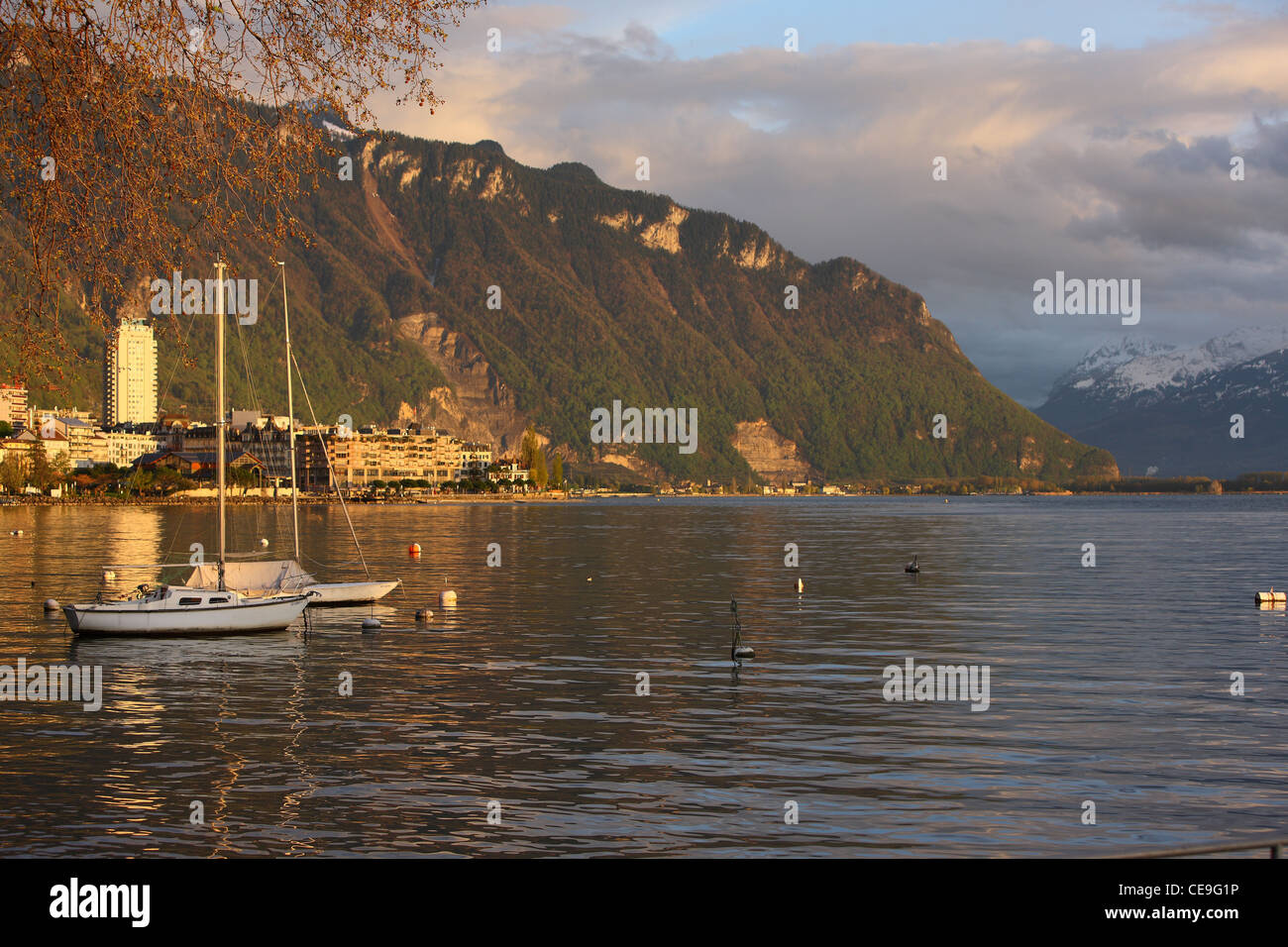 View of Lake Geneva in Montreux, Switzerland. Boats are on the water. Sunset in the Alps. Stock Photo