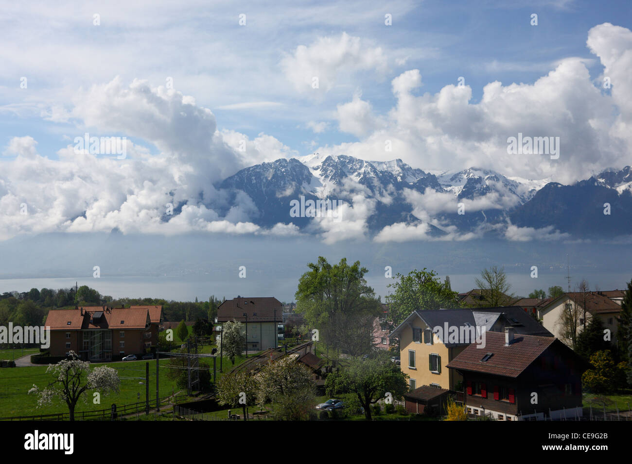 View of the snowy peaks of the Alps and Lake Geneva below. In the foreground is the town of Vevey, near Montreux and Lausanne. Stock Photo