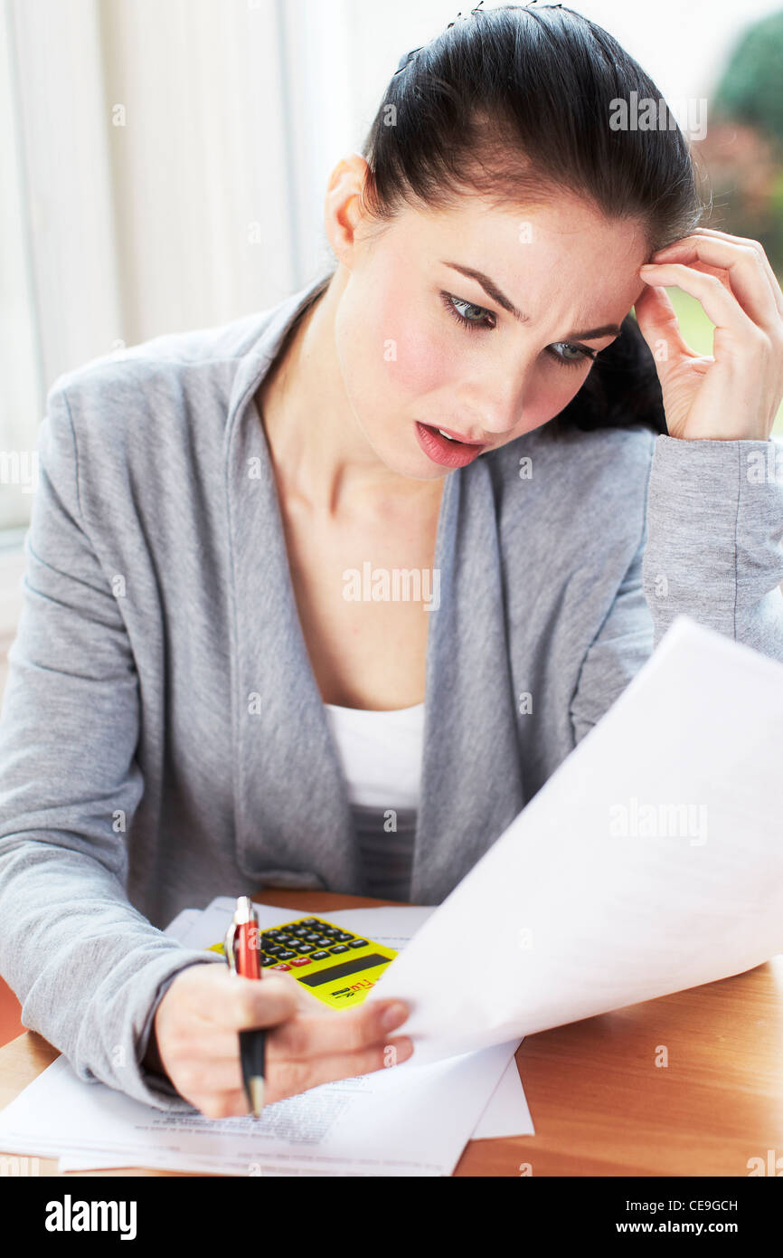 Woman working out bills Stock Photo