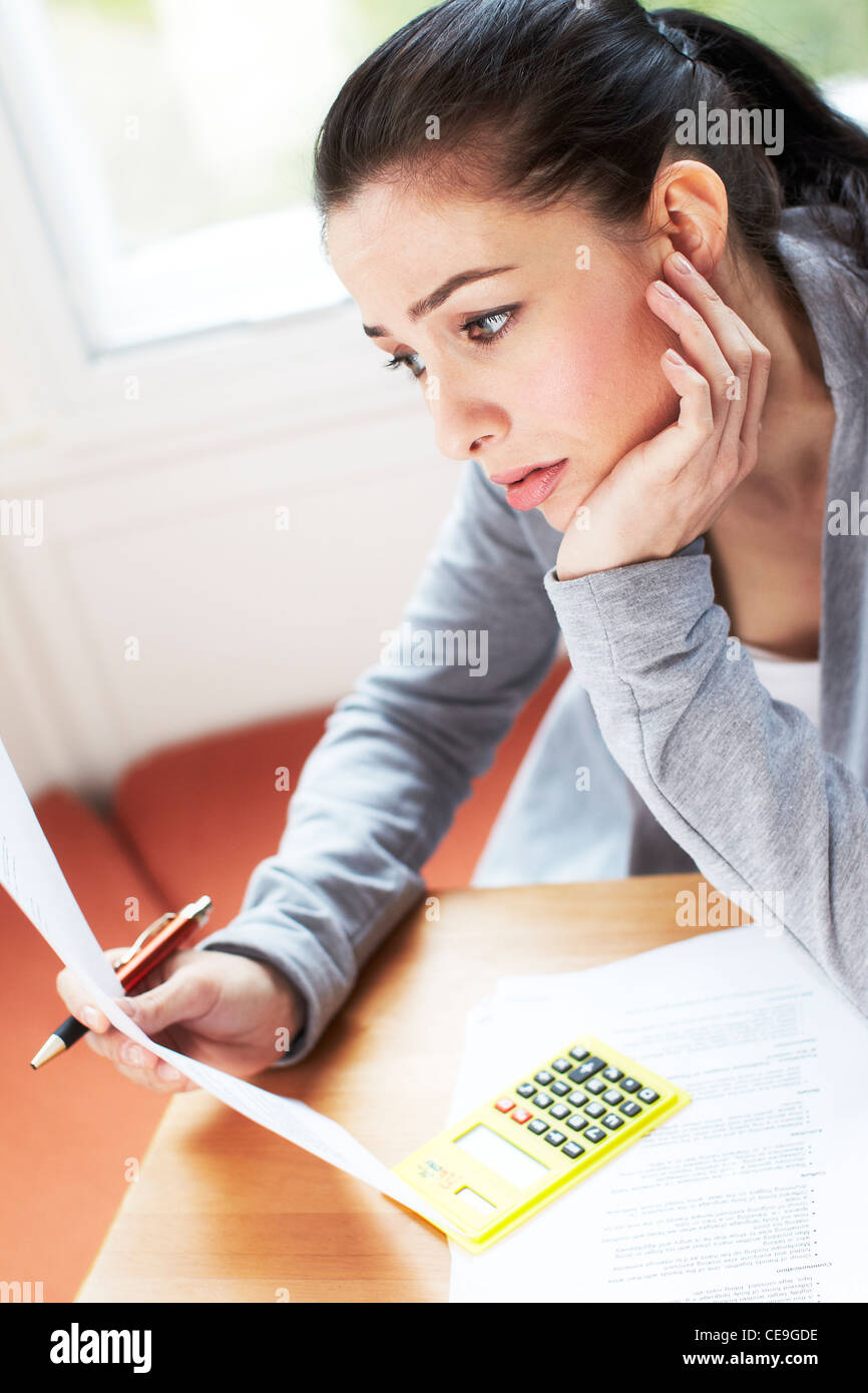 Woman working out bills Stock Photo