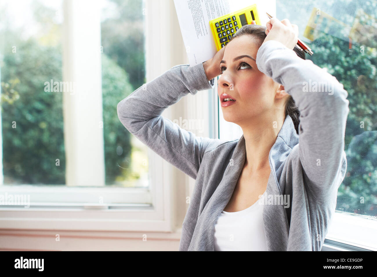 Woman working out bills Stock Photo