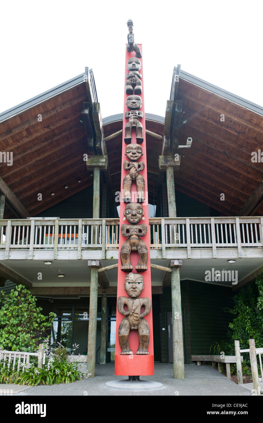 Maori cavings on the pou (guardian pole) at the Arataki Visitor Centre, Waitakere Ranges Regional Park. Stock Photo