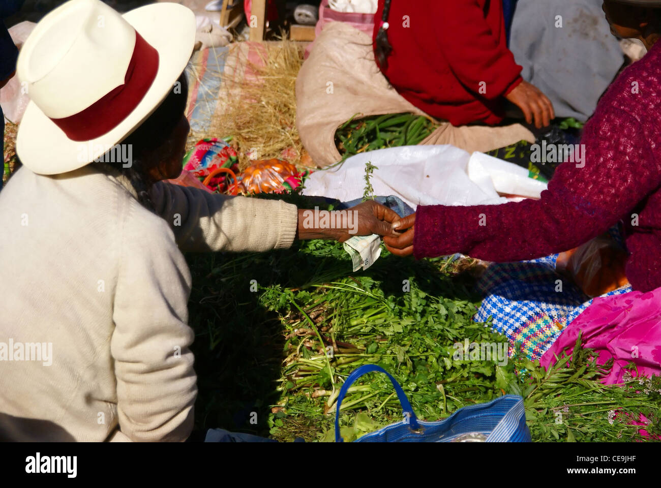 Indian women exchanging money at Pisac market, Cusco, Peru, South America Stock Photo