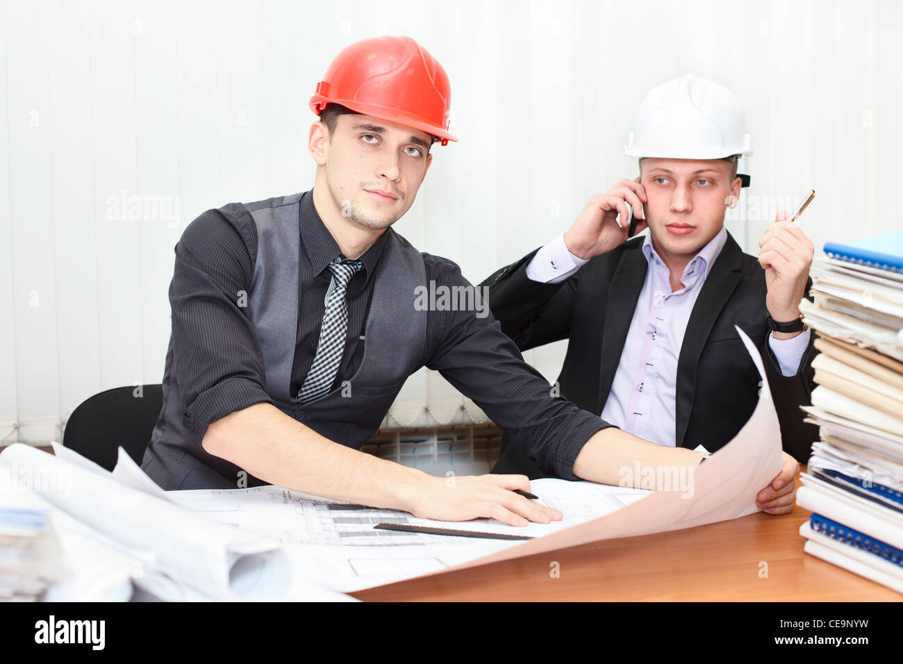 Architect and construction engineer discussing plan in office room ...