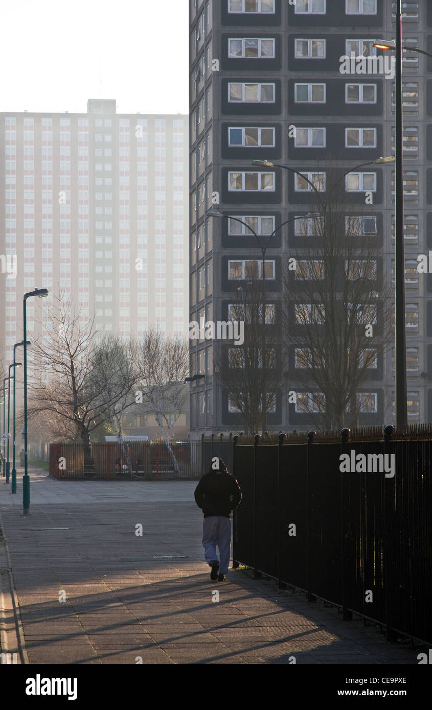 Young man walking through Pendleton housing estate, central Salford, Greater Manchester, England, UK Stock Photo