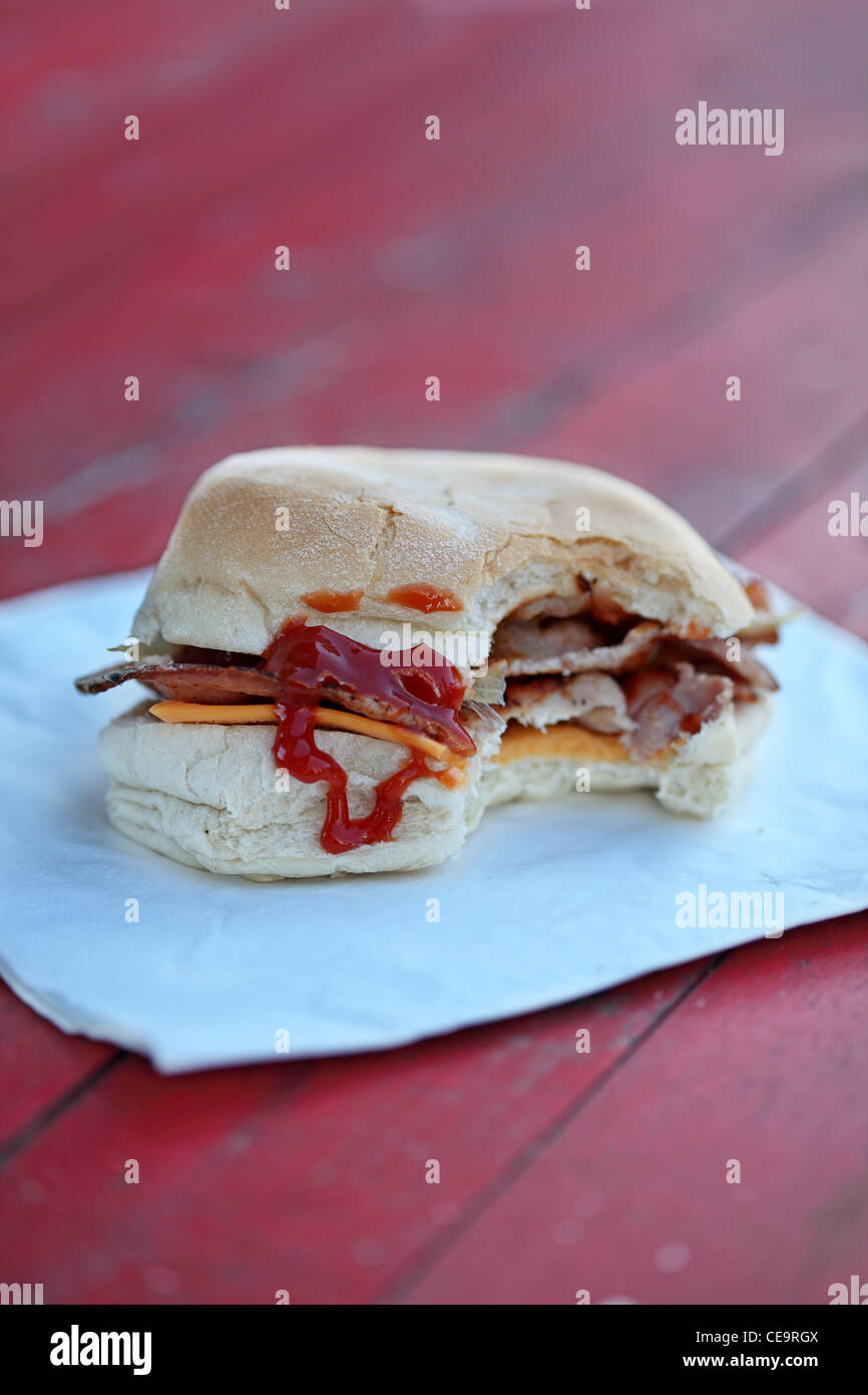 sandwich bacon barm eating on the street Stock Photo