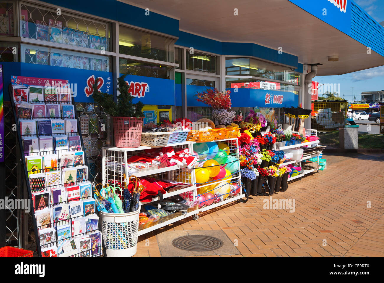 Christmas gifts, cards and beach balls on sale at $2 Mart. A colourful shop window in Orewa, North Island, New Zealand. NZ Stock Photo