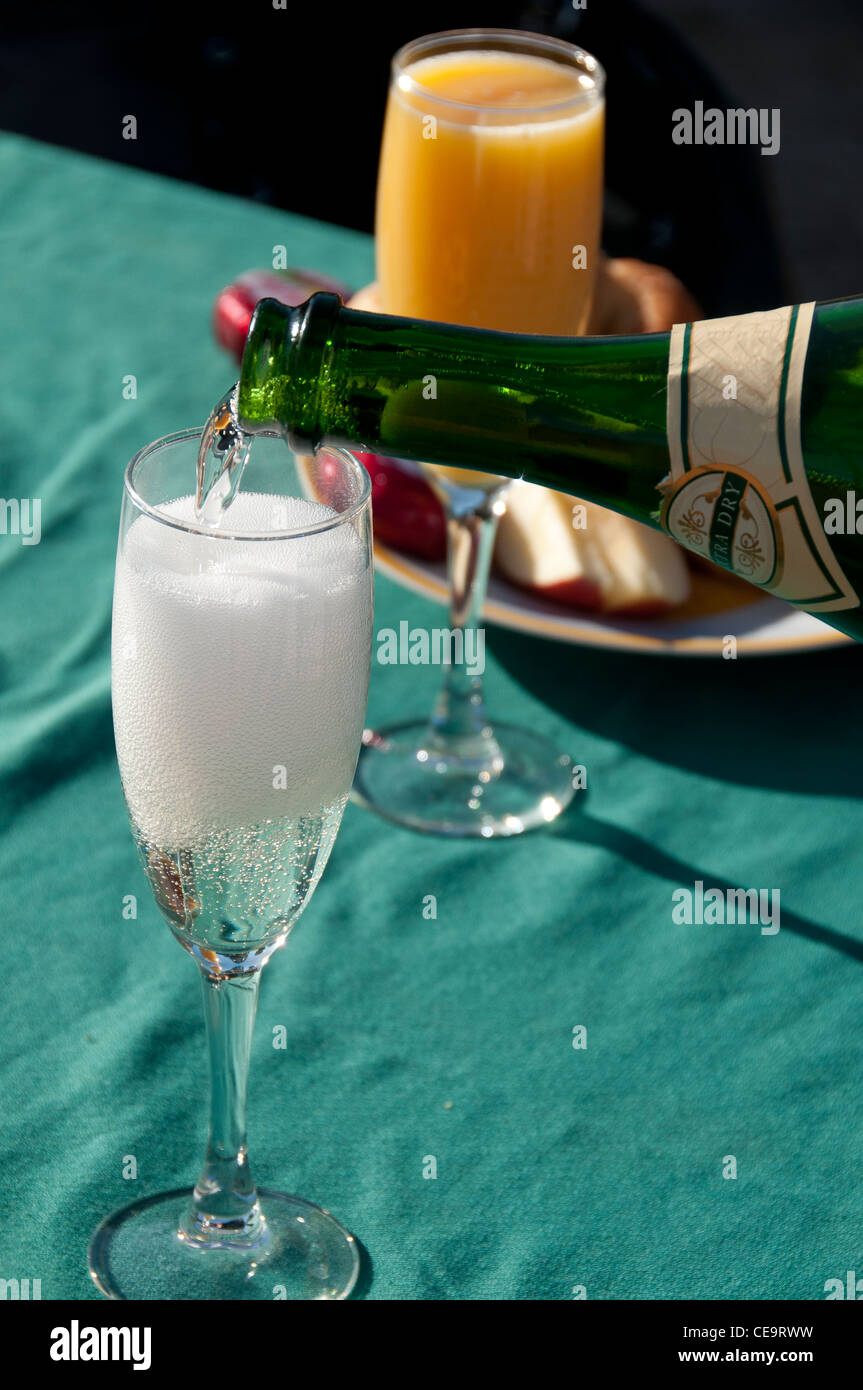 Pouring the sparkling wine at breakfast. Stock Photo