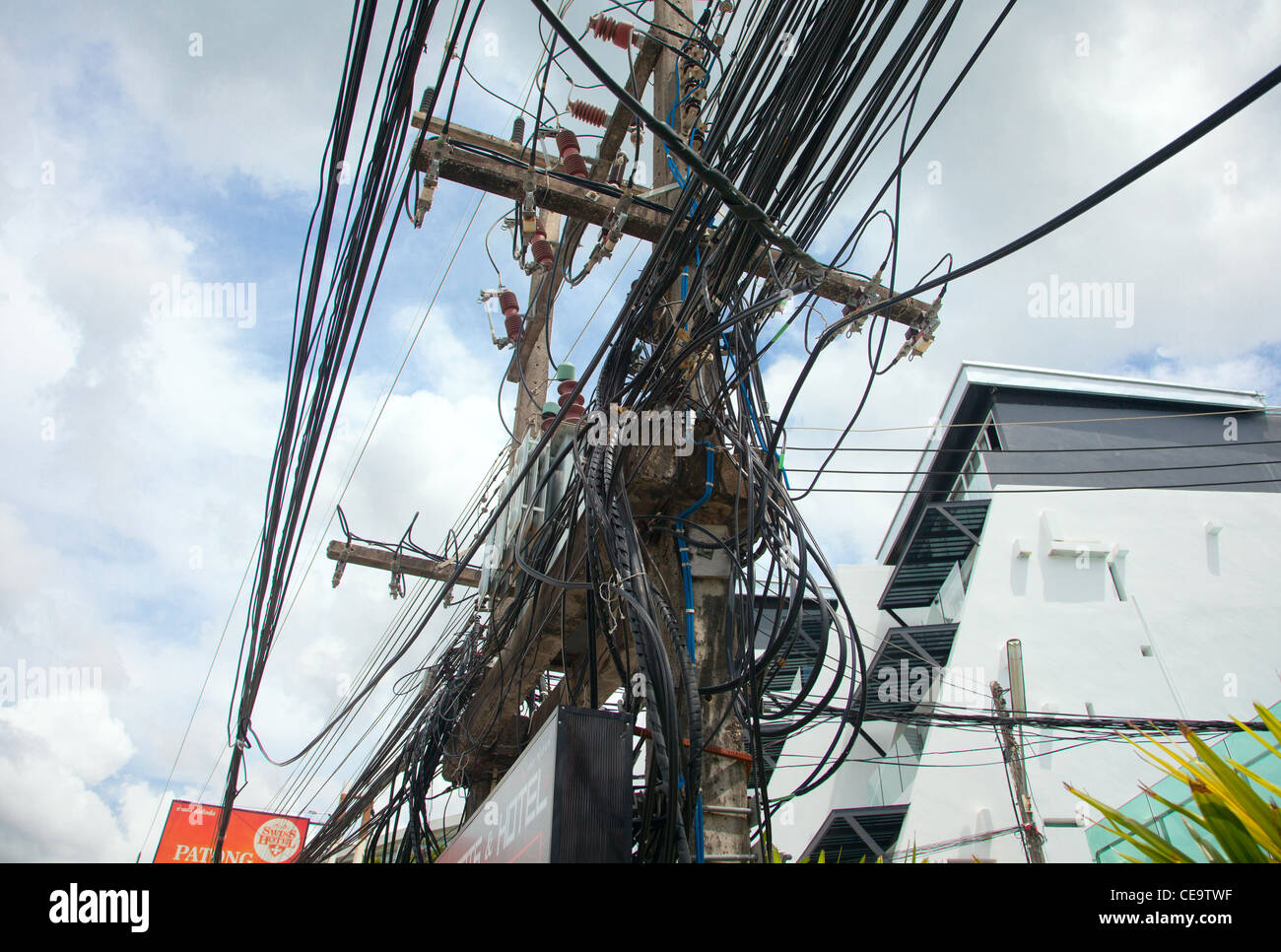 A lot of messy wires on a pole in Thailand Stock Photo