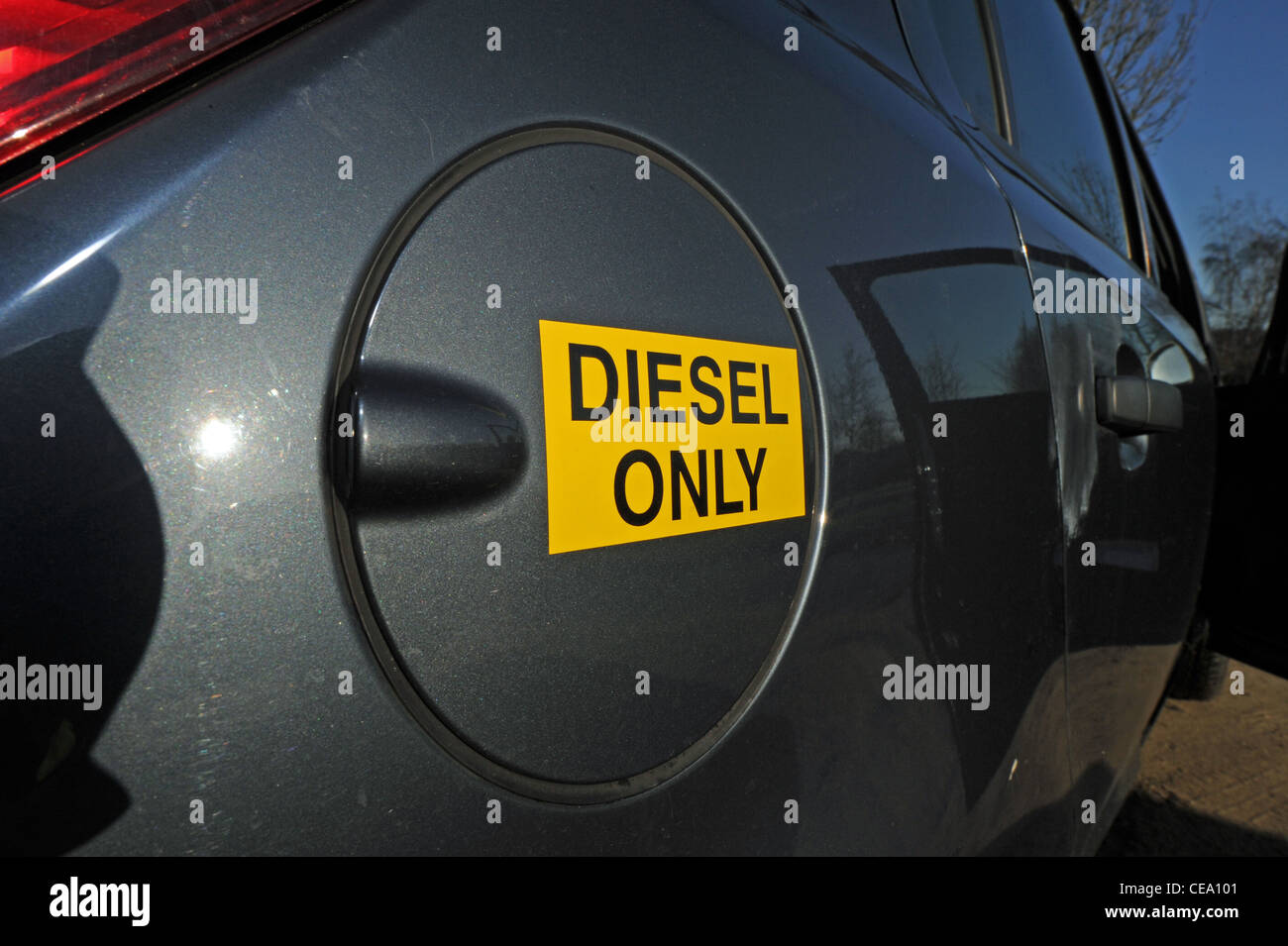 Filling a car up with diesel fuel taking off the fuel tank cap UK Stock