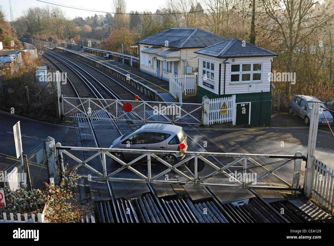 The old fashioned style railway line level crossing at the small village of East Farleigh in Kent UK Stock Photo