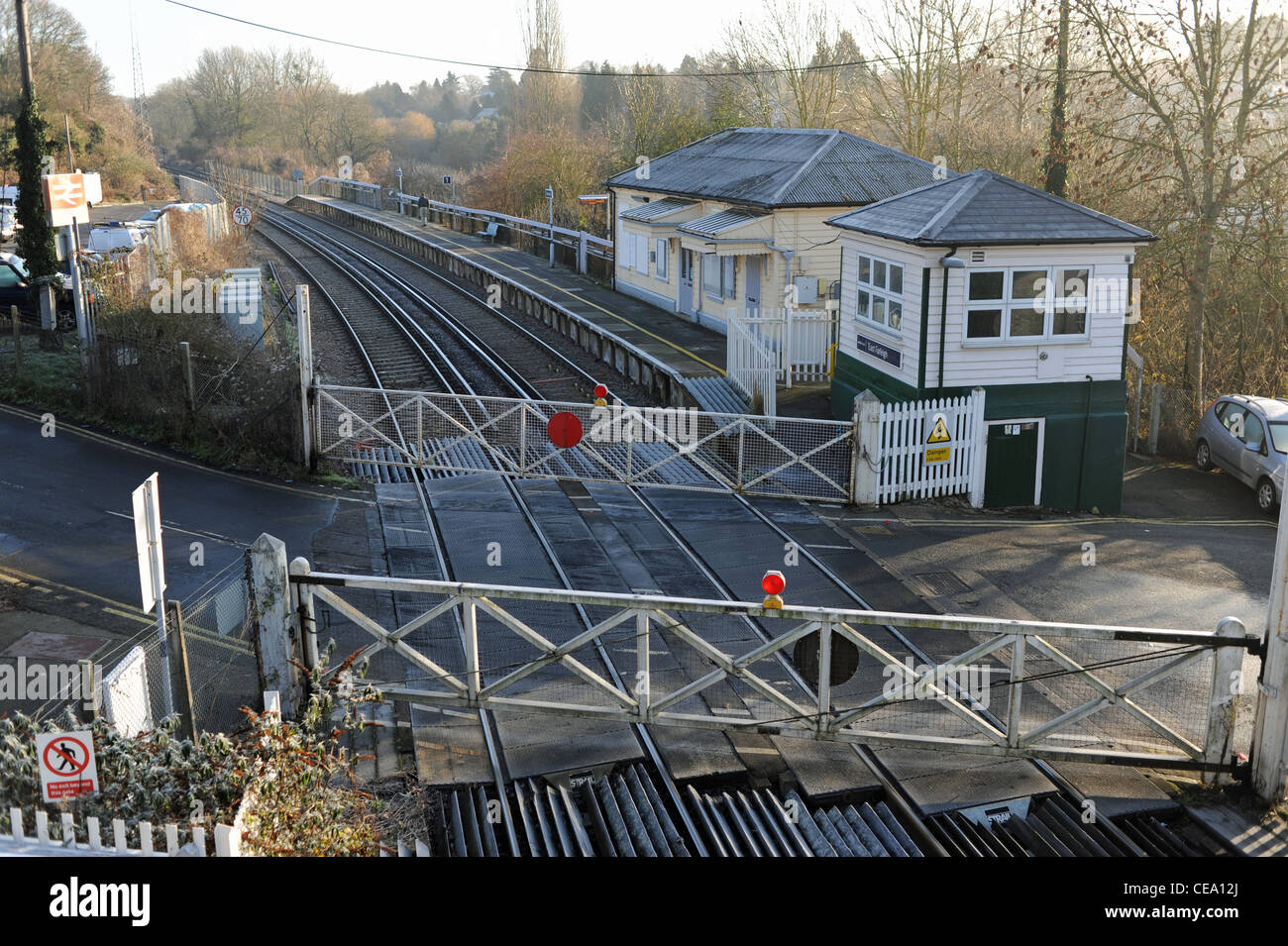 The old fashioned style railway line level crossing at the small village of East Farleigh in Kent UK Stock Photo