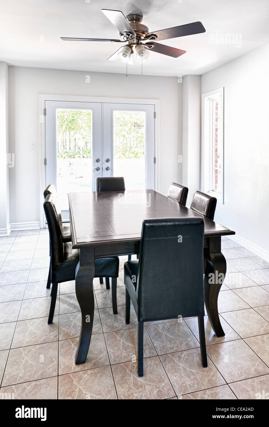 Room with dining table and chairs in upscale home Stock Photo Alamy