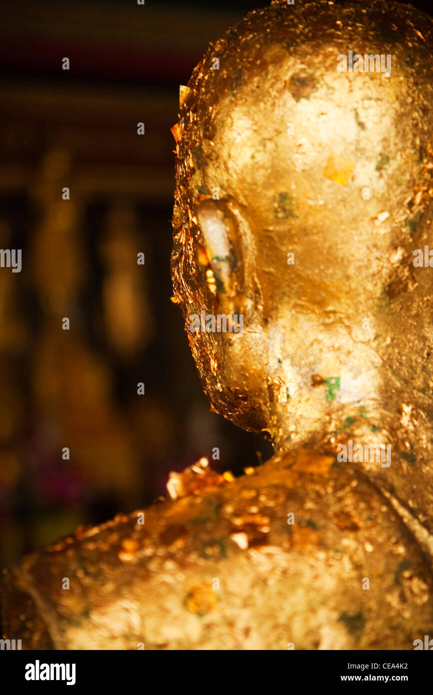 Statue with pieces of gold leaf offerings, Wat Po Temple, Phra Nakhon district, Bangkok, Thailand. Stock Photo