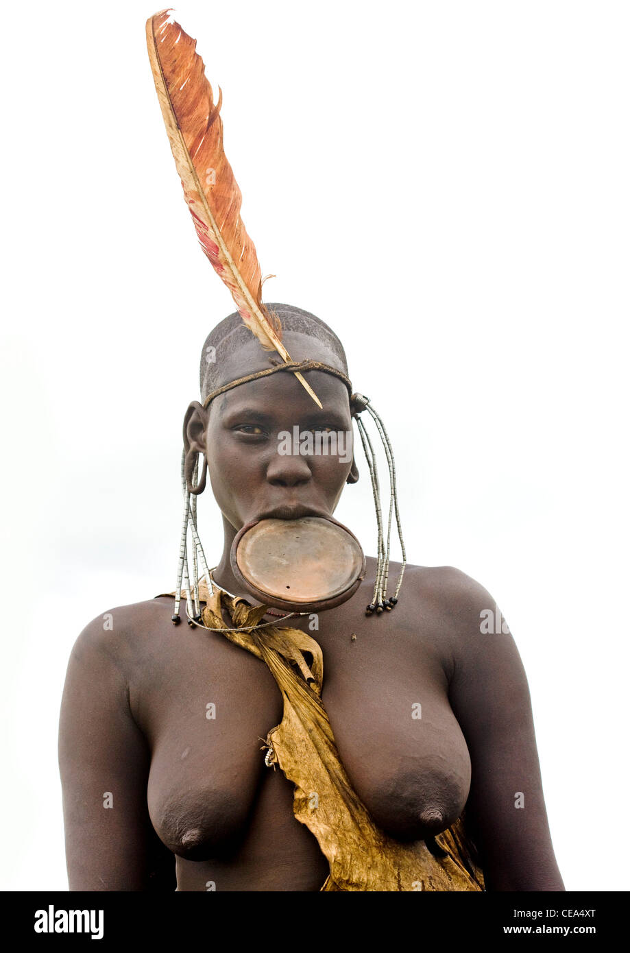Mursi Woman With Feather On Head And Naked Breasts And Lip Plate On  Ethiopia Stock Photo - Alamy