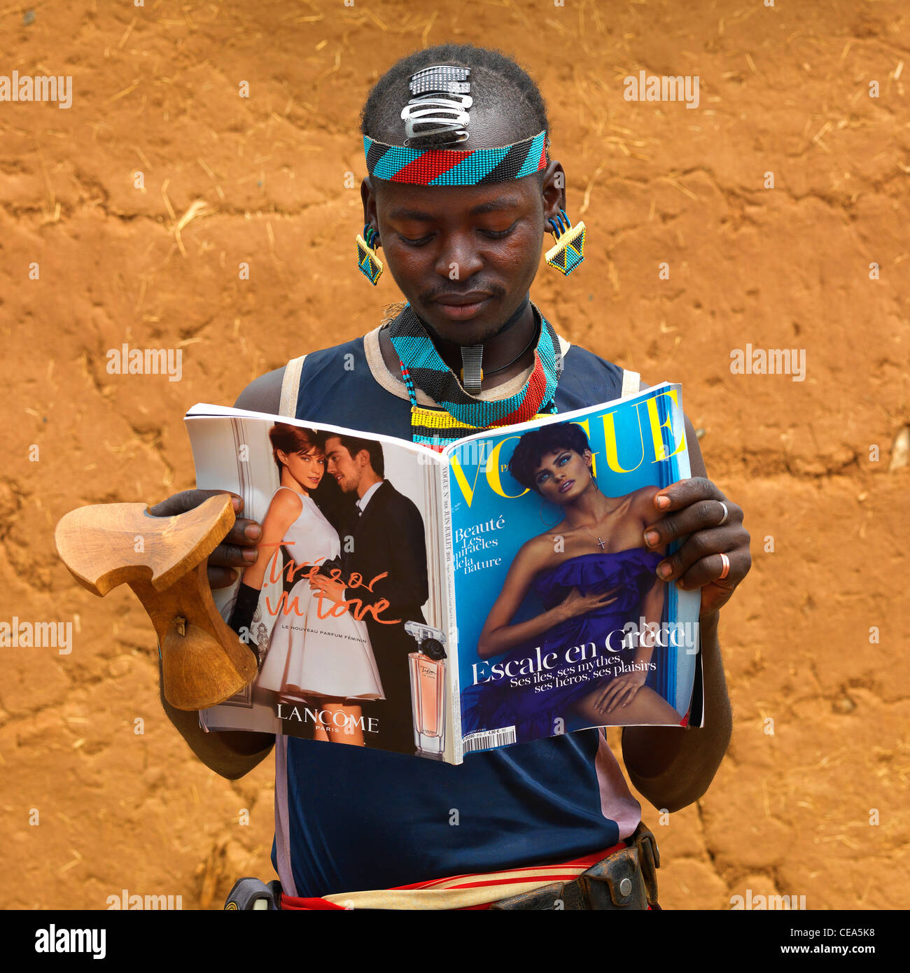 Young Fashionable Banna Man With Headrest Reading Vogue French Magazine Ethiopia Stock Photo