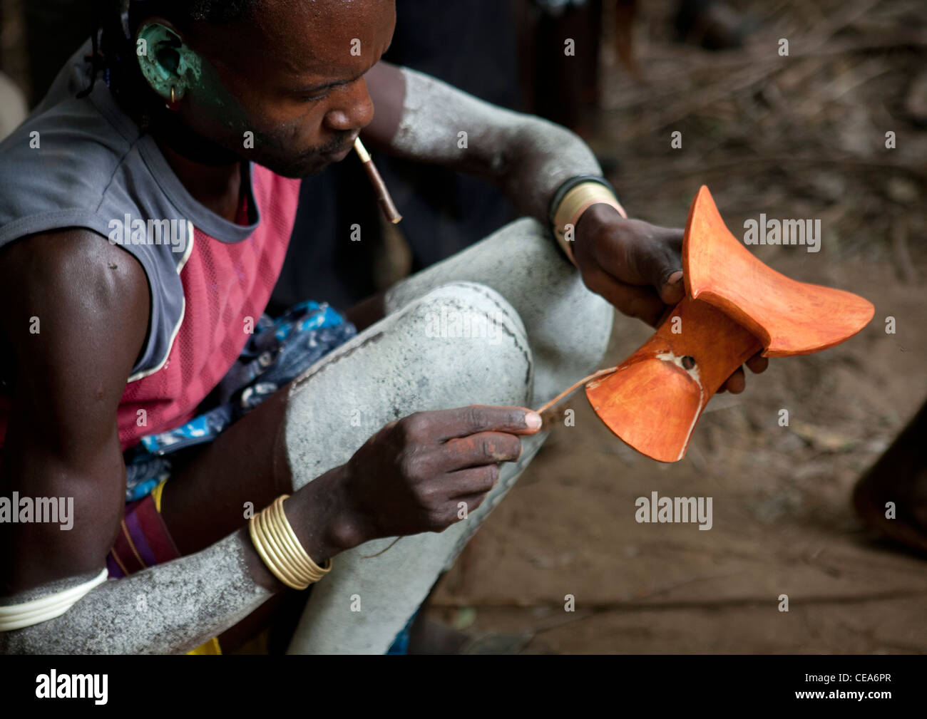 Hamer Man Painting Small Wooden Headrest With Ochre Omo Valley Ethiopia Stock Photo