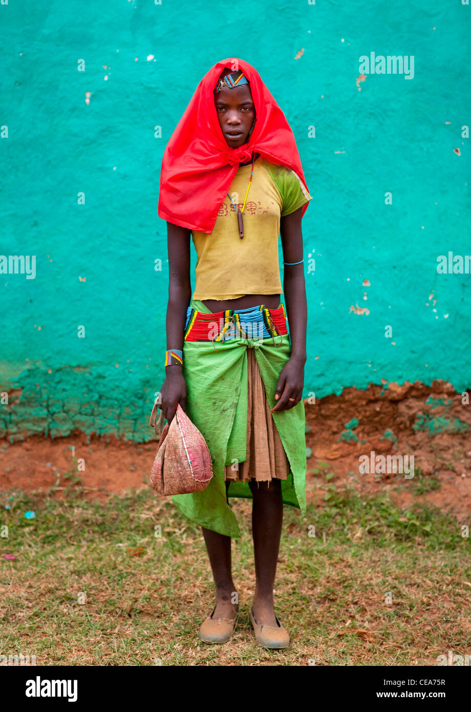 Standing Banna Teenage Girl With Whistle And Flushing Red Headscarf Omo Valley Ethiopia Stock Photo